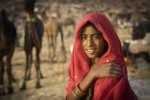 Beautiful young girl with red scarf at Pushkar
