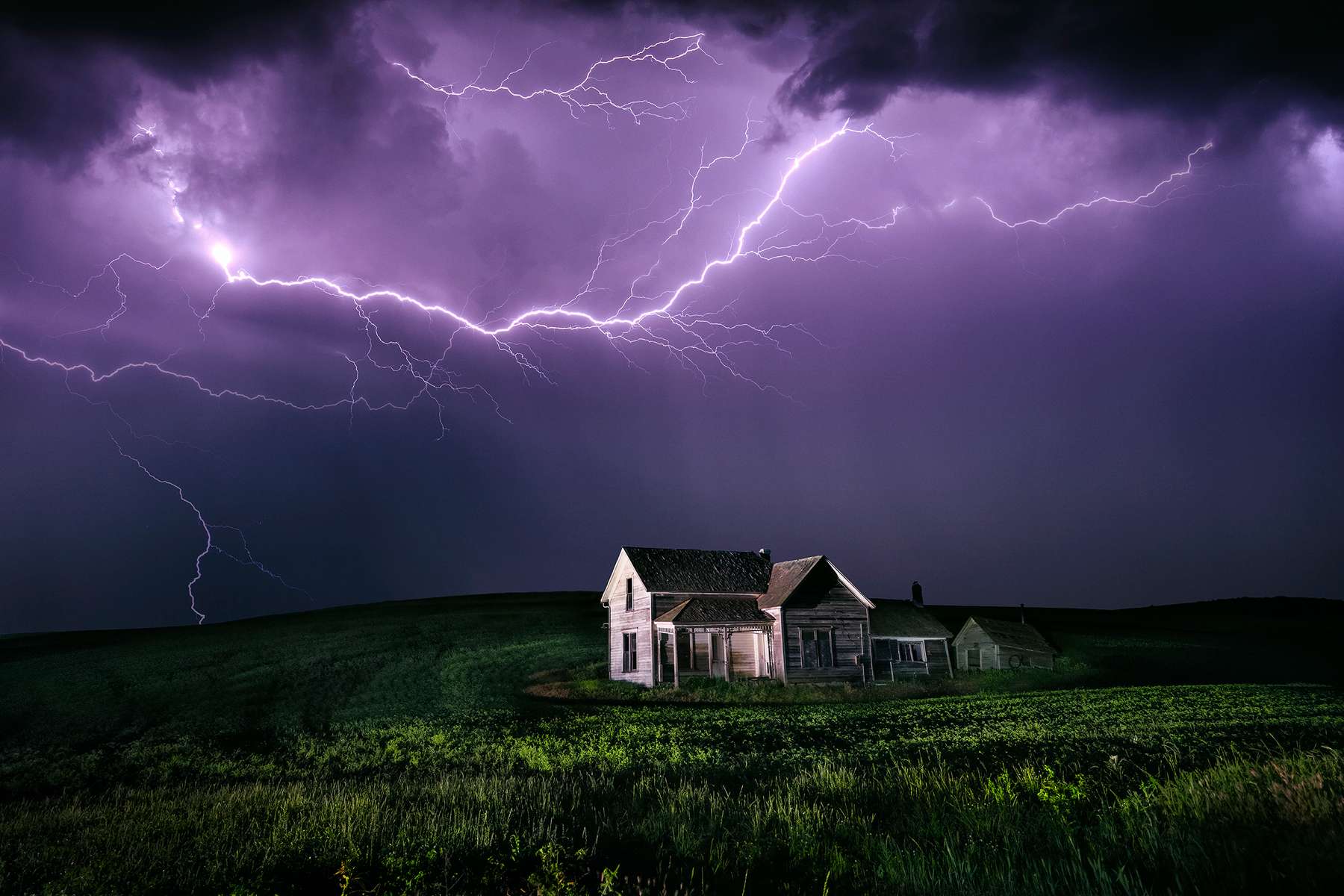 Lighting storm over abandoned home