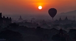 Hot air balloons floating above the temples of Bagan, Myanmar at sunrise