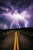 Lightning storm over mountain road