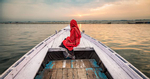 Woman on longtail boat on the Ganges River, Varinasi, India