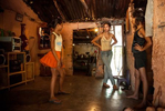 Dariana (left) dances in front of her sister Karen(center) and the neighbour Marisol (Right) in her house in El Cafetal neighborhood. While rough hewn and leathery in sound, vallenato lyrics are usually plain written and sugarcane sweet. Everyday events, passion, eternal love, village folklore, travelogues and miracles blur in the telling; voices crack, crackle with emotion in a music that so influenced Gabriel Garcia Marquez that he once described One Hundred Years of Solitude as a 350 page vallenato and inspired charcters such as {quote}.Remedios la Bella{quote}.