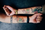 Two girlfriends with tattoos of their favorite Vietnamese dishes.