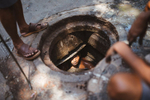Workers clean out a city sewer in the old town of Kolkata, India.
