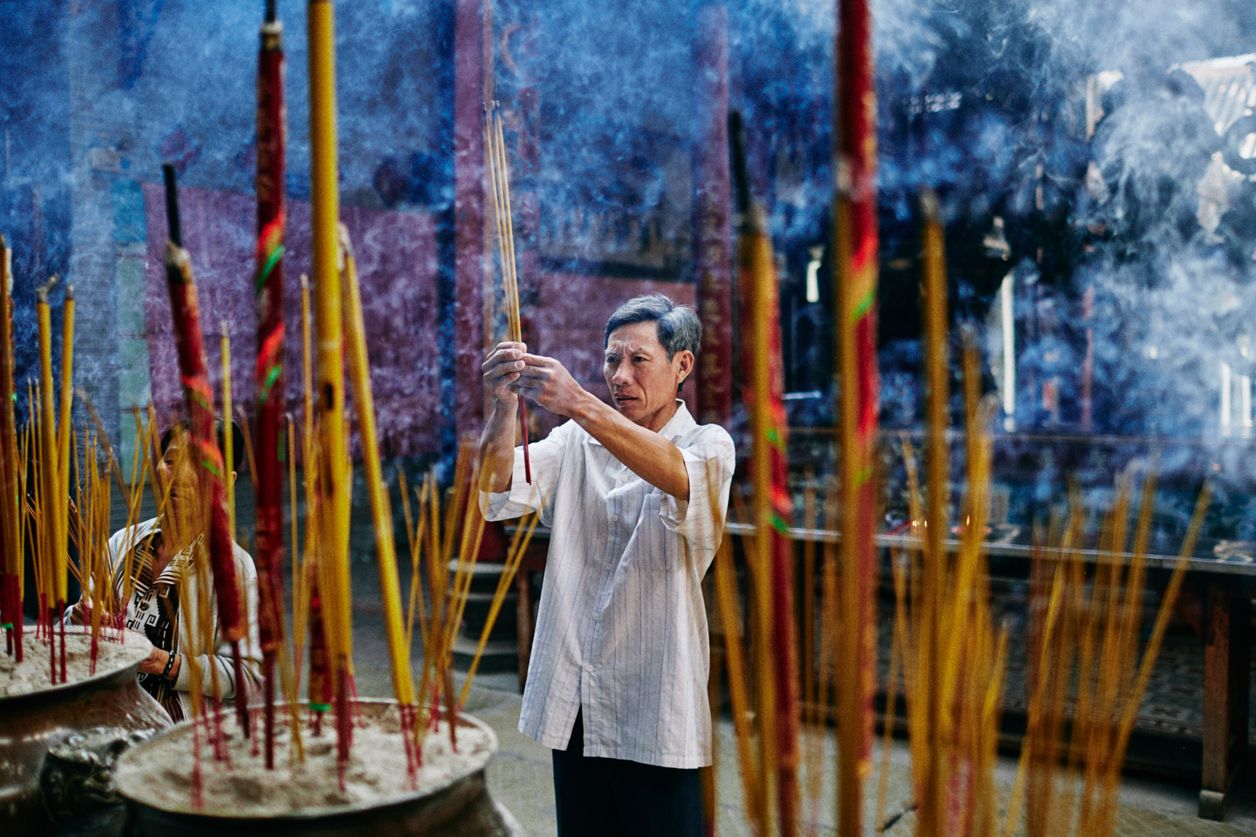 A man burns incense at Thien Hau Pagoda in Ho Chi Minh City, Vietnam.