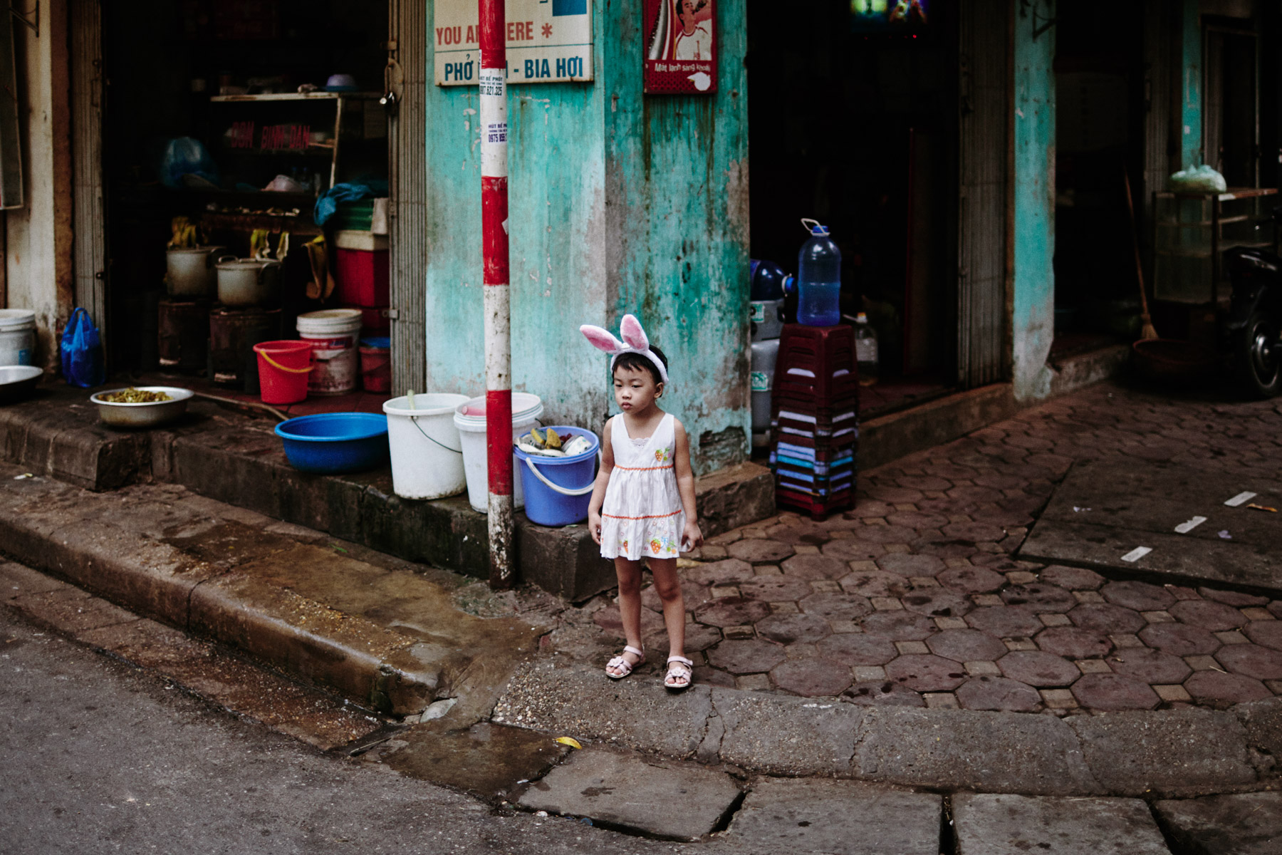 A young girl in bunny ears in the Old Quarter.