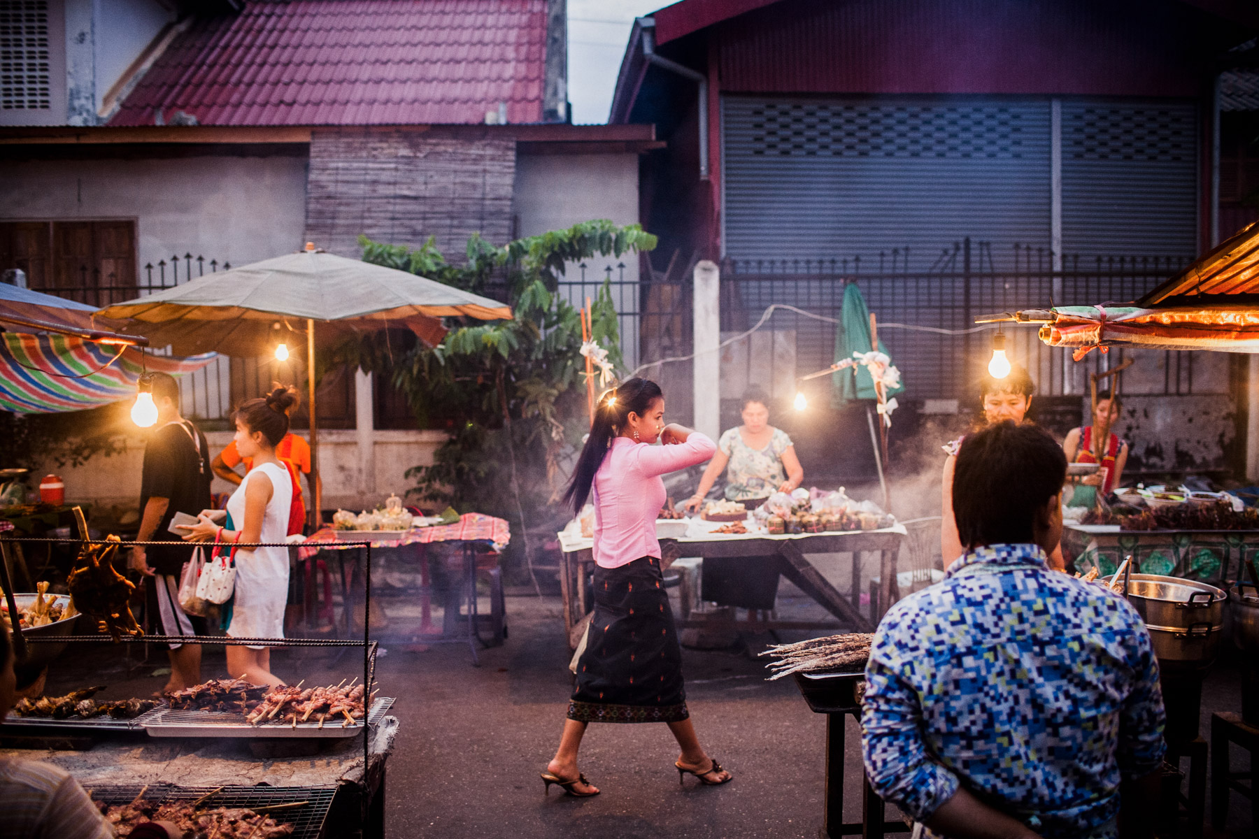 A woman walks through the Ban Anou night market in Vientiane, Laos.