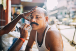 A man gets his mustache dyed on the streets of Kolkata, India.