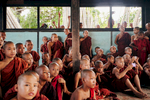 A group of novice Burmese monks watch a performance in a small town outside of Mandalay, Myanmar.