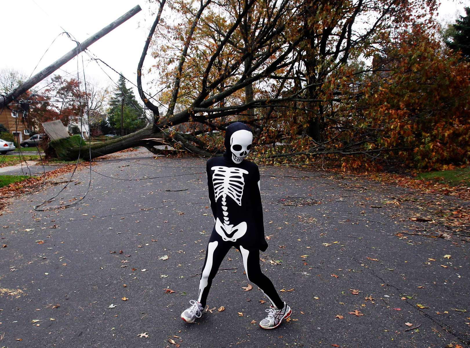 Aidan Christman, 10 of Scotch Plains plays in his Halloween costume on Montague Street to celebrate Halloween with neighbors after Hurricane Sandy in Scotch Plains.  Trick or Treating was cancelled due to the hurricane. 