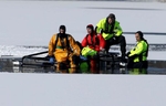 An amphibious vehicle sinks with rescue personnel as they try to retrieve a deer that was  being stuck on ice for more than 12 hours on a pond in Roxbury.