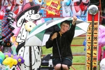 Brandon Swenson works and tries to keep dry at  the 42nd annual Monmouth County Fair at the East Freehold Showgrounds in Freehold.