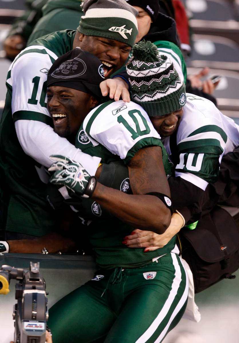 Jets receiver Santonio Holmes jumps into the stands after the game where he scored the go ahead touchdown with less than 30 seconds left in the game during the New York Jets versus Houston at the Meadowlands in East Rutherford.