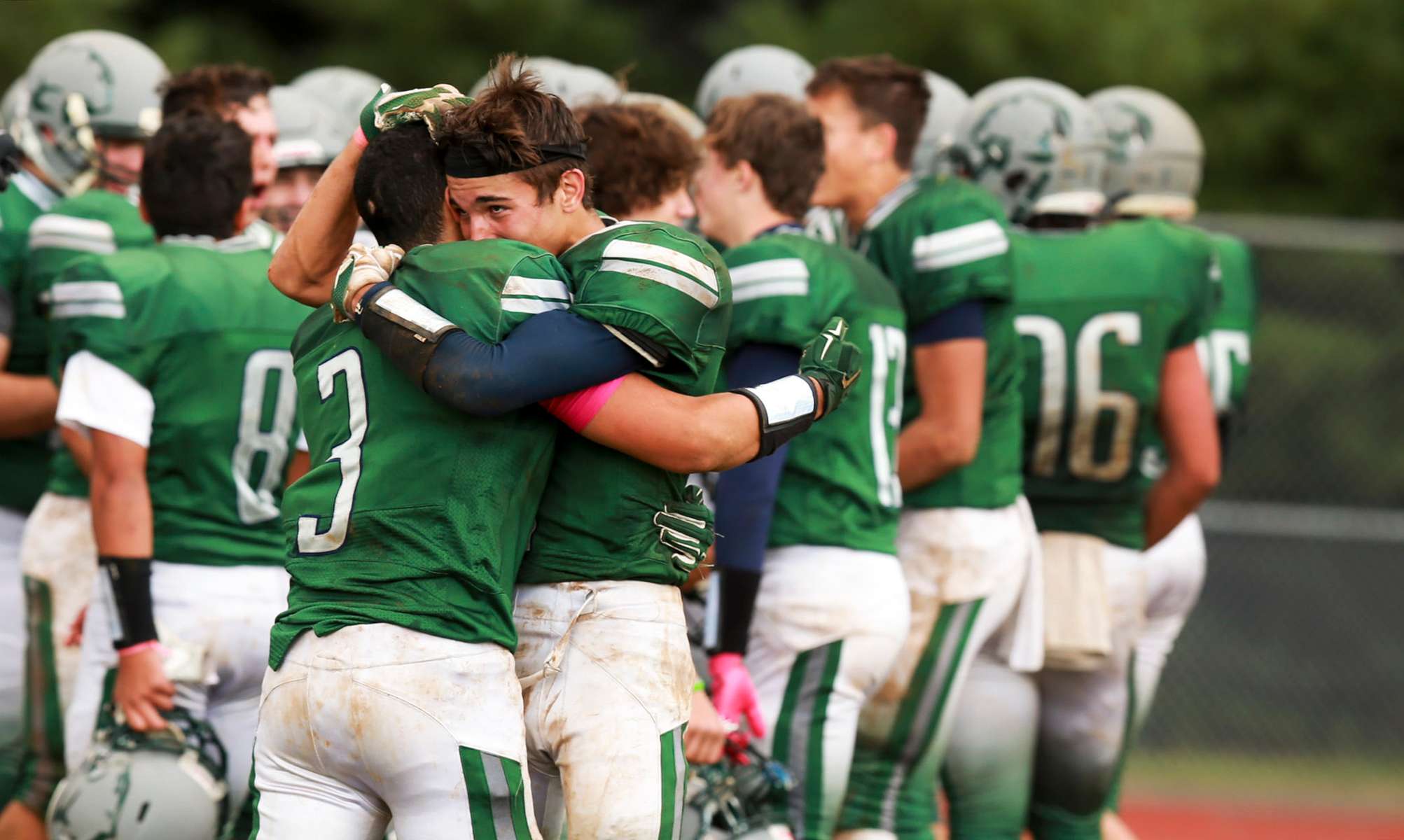Joe Barsky embraces a Colts Neck High School football player to celebrate a rare win 20-14 over rival Marlboro. They finished the season 3-7.