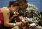 Carmelo Cruz of Willingboro holds his two week old daughter Athena Cruz  with his wife Angeline Cruz  during the last visiting time at the Freehold National Guard armory in Freehold before he departs for training and then Iraq.  New Jersey National Guard Bravo Company 1-114th. 