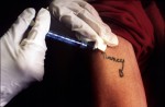 A shot to boost his white blood cells is injected next to his tattoo of his former girlfriend after they broke up three years ago. After the rejection he became a bar fly and then was diagnosed. She is not infected. 