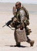 A marine carries his MRE in his teeth while wearing body armour, weapon and carrying a water container in the 108 degree heat of the Mojave desert. New Jersey Marines in training at the Marine Air Ground Task Force Training command at Twentynine Palms.