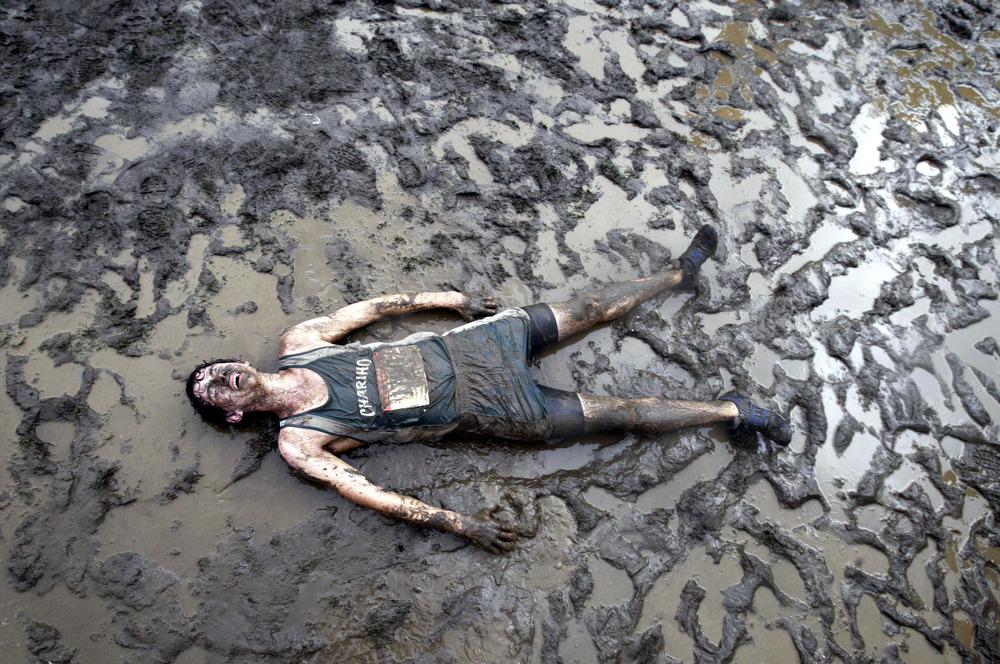 Charrio High School runner becomes one with the mud after the rains hits the cross country course  at the New Jersey Runners at the Manhattan Cross Country invitational in the Bronx.