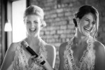 Bridesmaids laugh while delivering speech at wedding at Pearl St. Grill and Brewery in Buffalo, NY.