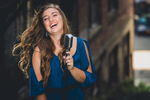 senior portrait by photographer Lindsay DeDario of maple grove high school student laughing with microphone in Jamestown, NY, a small city near Buffalo in WNY 