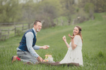 bride and groom enjoy wedding cake in field at Knox Farm State Park during their small, intimate wedding elopement celebration