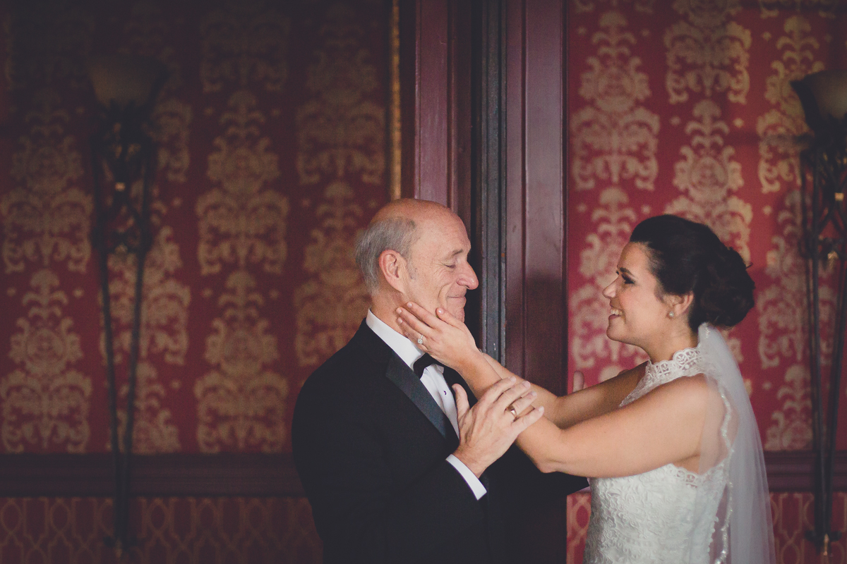 bride holds fathers face after first look in Georgian Ballroom at her Statler City wedding in Buffalo, NY