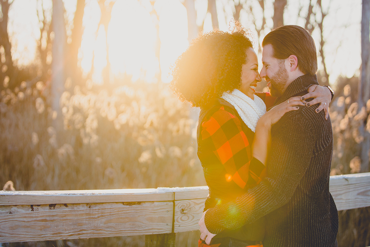 couple laughs in woods during wedding engagement photography session at Tifft Nature Preserve in Buffalo, NY