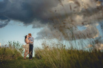 bride and groom kiss during sunset in field at Tifft Nature Preserve in Buffalo, NY during their wedding engagement photography session