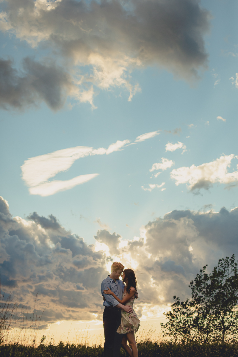 bride and groom embrace on hill during sunset at Tifft Nature Preserve in Buffalo, NY