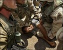 A demonstrator in Baghdad is subdued after he demanded the bodies of two demonstrators killed by U.S. troop fire be released. The Iraqis are former soldiers protesting over their pay.
