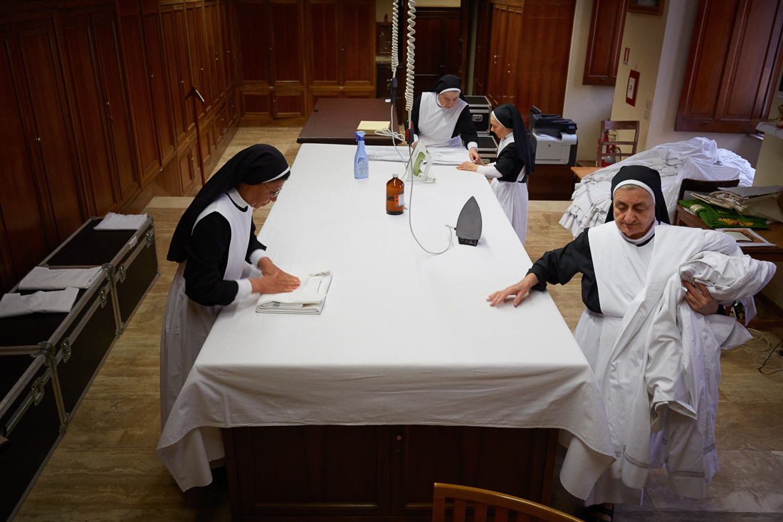 Nuns iron robes to be worn by priests at Vatican City masses.