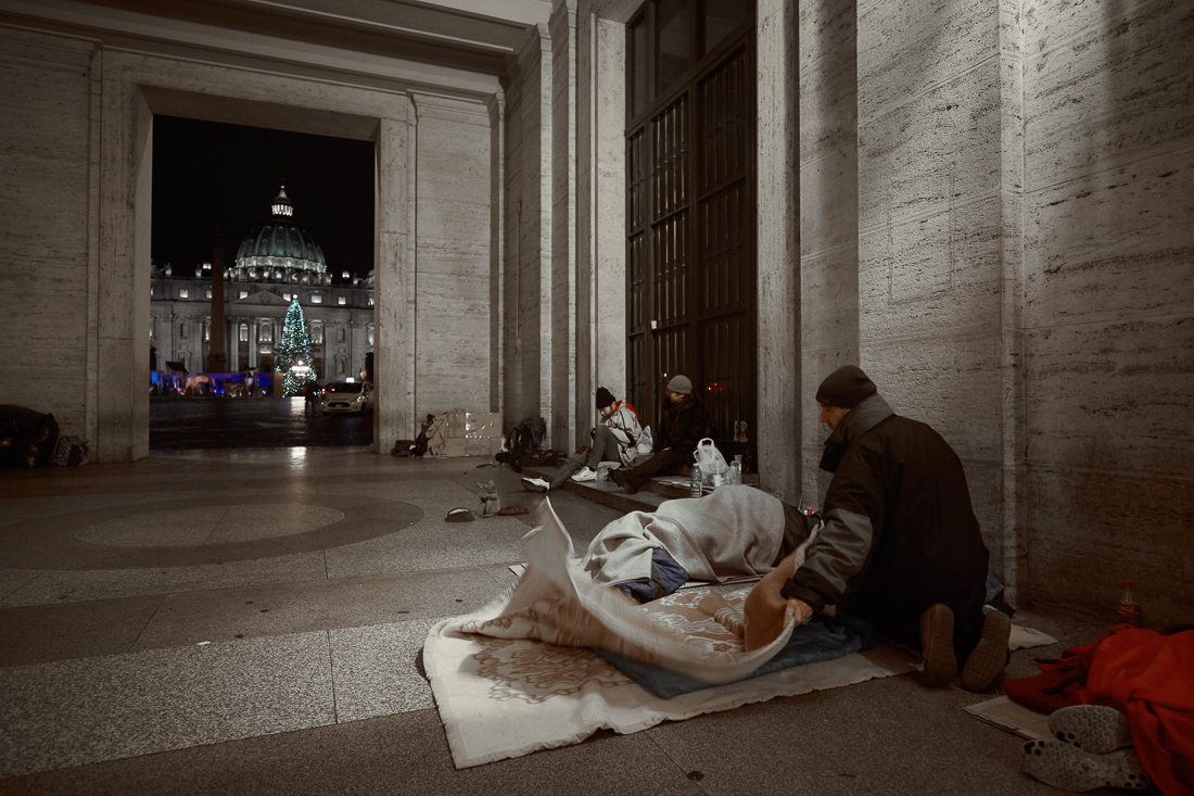 Although the Vatican charity wing is very active in Rome and throughout Italy, homeless people sleep most nights within a stone's throw of St. Peter's Square. In the case of this picture, most of them found local shelters to be full and had to spend a January night on Via della Conciliazione in Rome. They did not want to give their names but the identifiable ones gave verbal consent to be photographed.