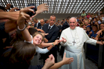 An enthusiastic pilgrim takes a selfie photo with Pope Francis during a general audience in Vatican City.