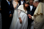 Pope Francis blesses newlyweds during a general audience.
