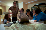 Team specialists Anna Cohen, in plaid shirt, Chris Fisher in IPA t-shirt, Juan Carlos Fernandez Diaz in kaki shirt,, Oscar Neil Cruz in black t-shirt, and Alicia Gonzalez in blue shirt, reviewing LiDAR images and maps before their foray into the jungle to search for a lost city in the Mosquitia in Honduras.From an airfield near Catacamas, Honduran soldiers, former British SAS commandos and scientists penetrated the Mosquitia jungle by helicopter to investigate structures left by an ancient culture that were neighbors to the Maya.