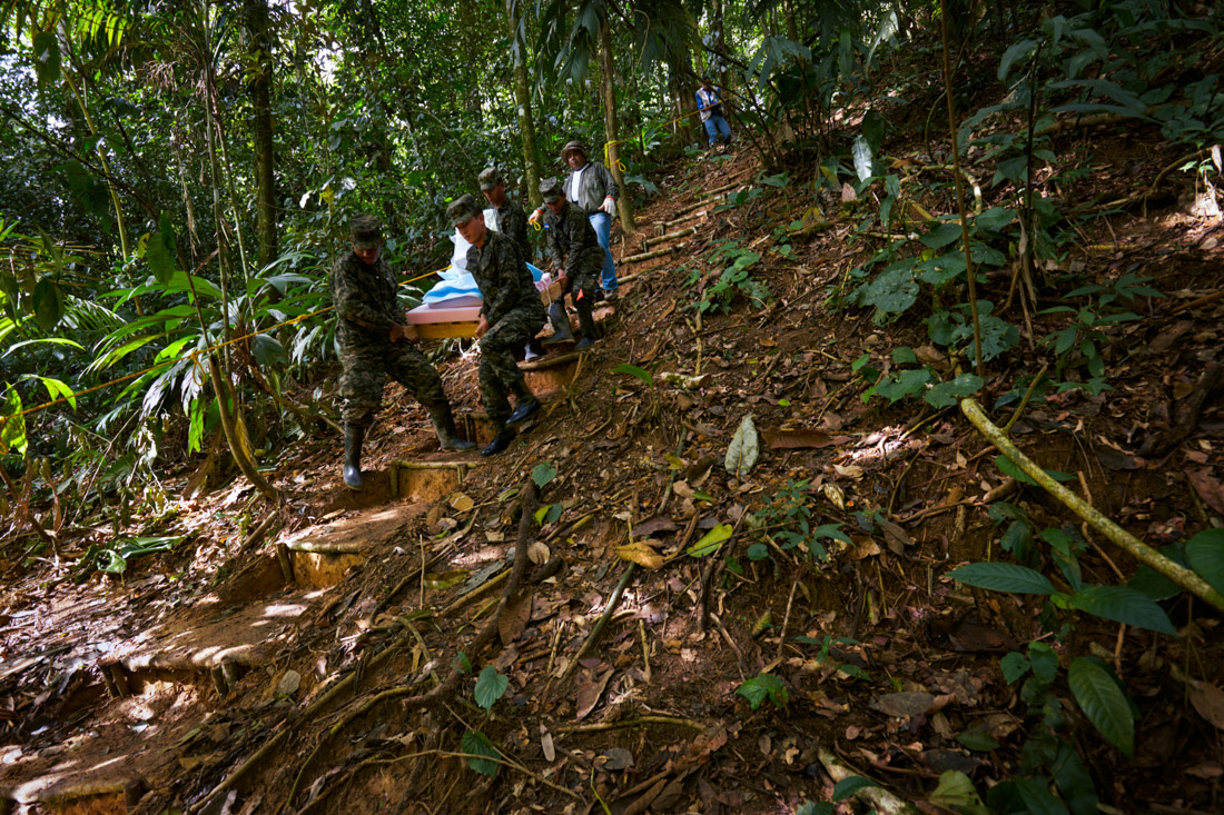Excavated artifacts are carried to an awaiting Honduras military helicopter for transportation to the lab near Catacamas.