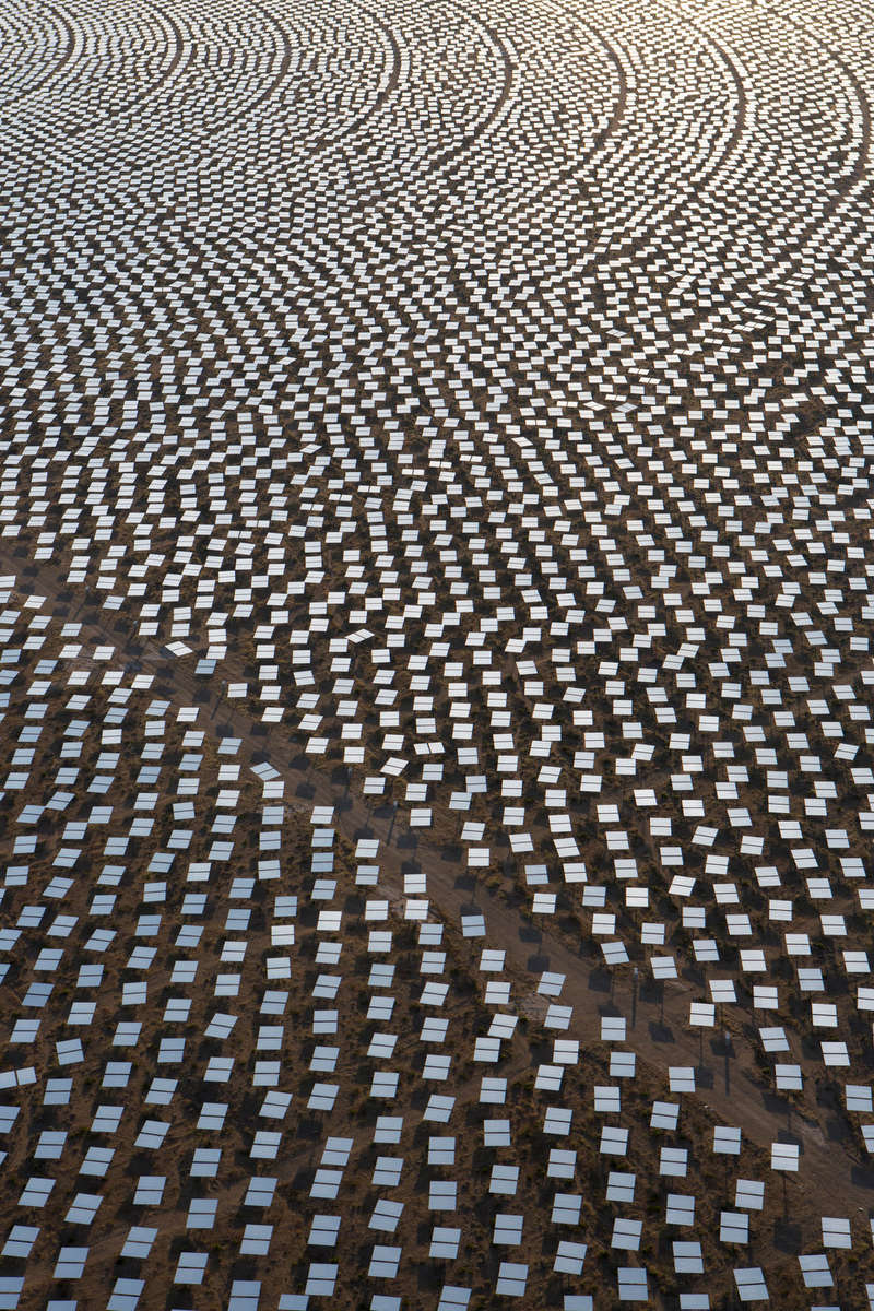 IVANPAH, CALIFORNIA, SEPTEMBER 18 2012: An aerial view of Tower One's heliostats at the Ivanpah Solar Power Facility. Located in the Mojave Desert 40 miles southwest of Las Vegas, The Ivanpah Solar Power Facility is a solar thermal power project, currently under construction, with a planned capacity of 392 megawatts, enough to power approximately 140,000 houses. It will deploy 170,000 heliostat mirrors spread over 4,000 hectares, focusing solar energy on boilers located atop three solar power towers, generating steam to drive specially adapted steam turbines The project, developed by BrightSource Energy and Bechtel, will cost $2.2 billion and be the largest solar farm in the world (photo Gilles Mingasson for the Smithsonian).
