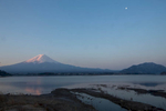 Mt. Fuji reflects in the waters of Lake Kawaguchiko at sunrise.