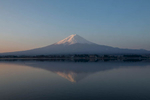 Mt. Fuji reflects in the waters of Lake Kawaguchiko at sunrise.