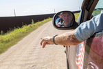 Rusty Monsees, an anti-immigration activist whose land is cut in half by the border wall, drives on his property between the fence and the Rio Grande, a no man's land.