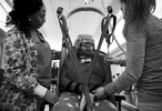 Erika Jones, 32,  is on the slow path to recovery from a brain tumor that left her paralyzed and unable to speak more than a few words. Her mother Joyce Jones insisted she be moved back into her family's home rather than a nursing facility. {quote}I am committed to caring for my baby until the day I die,{quote} Joyce explained. {quote}She wouldn't get that love in a nursing home.{quote} 