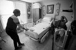 Erika Jones, 32,  is on the slow path to recovery from a brain tumor that left her paralyzed and unable to speak more than a few words. Her mother Joyce Jones insisted she be moved back into her family's home rather than a nursing facility. {quote}I am committed to caring for my baby until the day I die,{quote} Joyce explained. {quote}She wouldn't get that love in a nursing home.{quote} Pictured: Joyce Jones chats with Erika in what was once family dining room, now converted to Erika's room on the ground floor. 