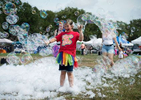 Shane Summers, a gender-fluid preteen, plays in a field of large bubbles at the city’s OUT in the Park Gay Pride Festival on Tampa Bay.  Instead of hosting one of the  largest Gay Pride parades in the country, local organizers opted for a series of smaller events spread throughout June, considered Gay Pride Month.The scaled back celebrations were due to COVID-19 precautions, though few attending Saturday’s waterfront OUT in the Park festival used masks. 