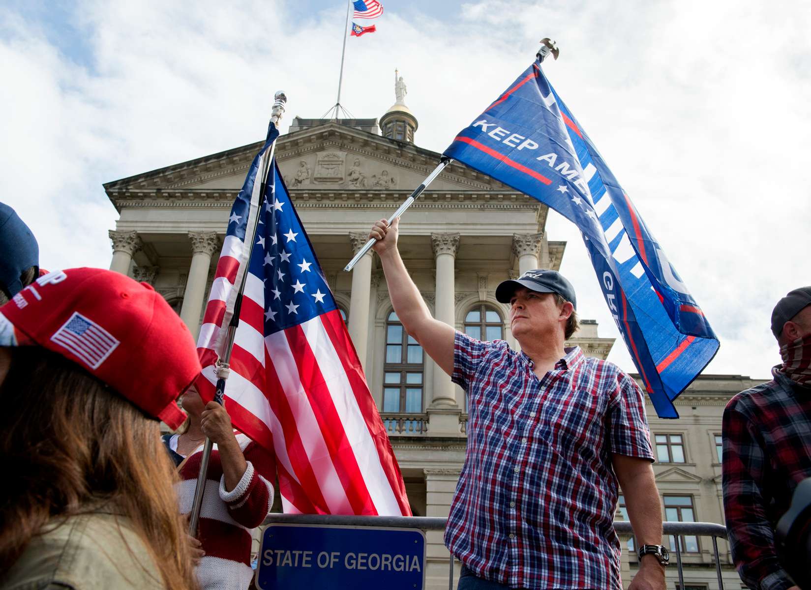 Republican Trump supporters protest what they claim are illegal mail-in votes in Georgia election at ‘Stop the Steal’ demonstration outside Georgia statehouse Saturday, at the same time hour former Vice President Joe Biden was declared  unofficial winner of 2020 presidential election.