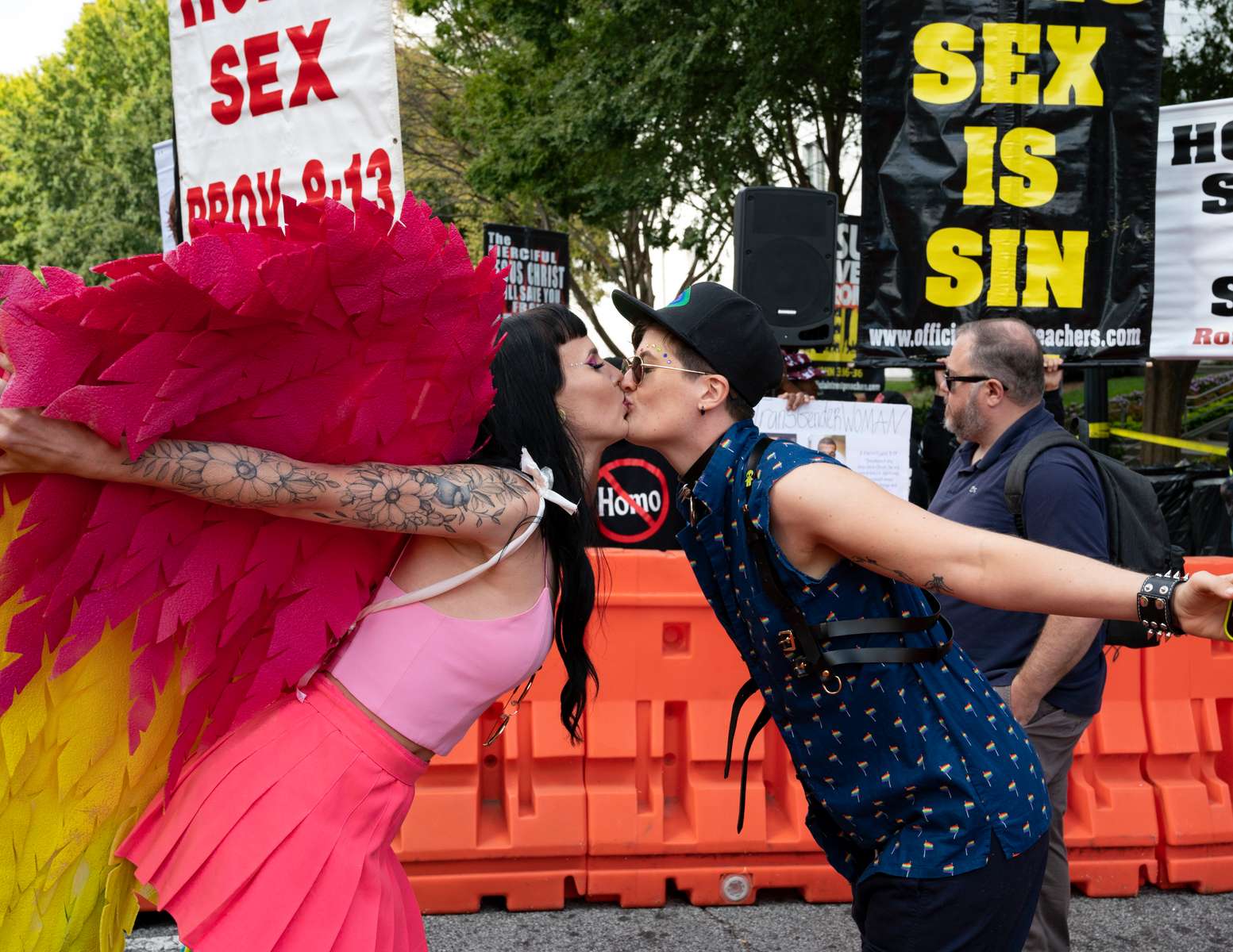 Thousands from Atlanta’s LGBTQ community  jammed the city’s midtown district for the 3-hour-long Pride parade, after a two-year hiatus because of COVID-19. Pictured: A lesbian couple kiss as street preachers behind them taunt and insult the crowd.