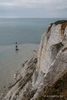 Colour photograph of the chalk cliffs at South Downs National Park lookis down to the Beachy Head Lighthouse