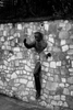 black and white photograph of a statue of a man running through a wall in Montmartre Paris France