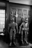 black and white photograph of two suits of armour standing on guard by teh door