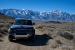 Colour photograph of a Land Rover Defender off-road in the Alabama Hills wth the Eastern Sierra in the background, CA