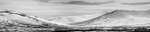 Black & white landscape photograph of snow covered mountains off the Taylor Highway nrear Nome, Alaska